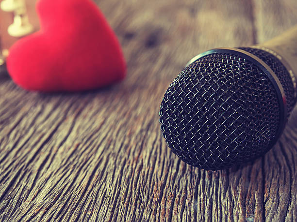istock Music lover concept. A Black microphone on wooden plate. 521464796