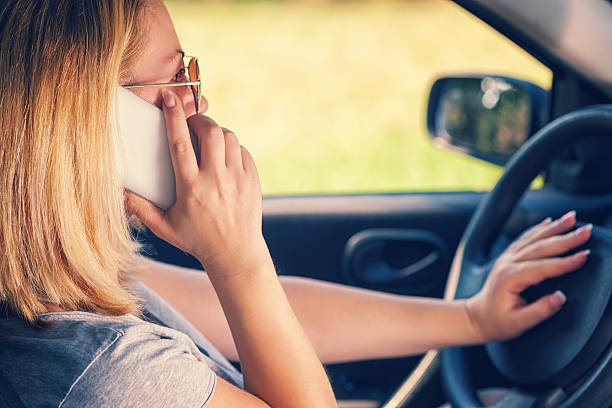 istock Young Woman Using Smart Phone in Her Car 521465852