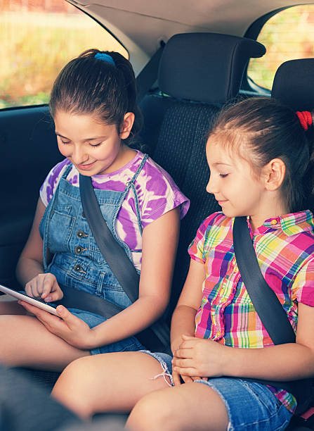 istock Children Travelling in Car With Tablet 521466576