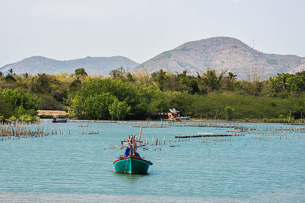 istock Fishing boat moored on the coast sea with mountains. 521467356