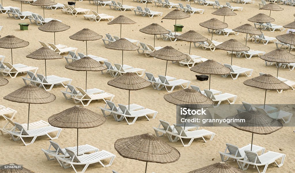 wicker umbrellas on the beach, view from above At The Edge Of Stock Photo