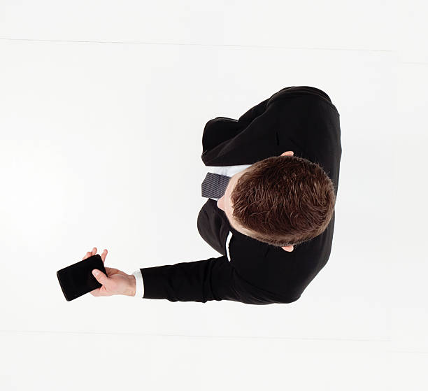 istock Above view of businessman using phone 521468380
