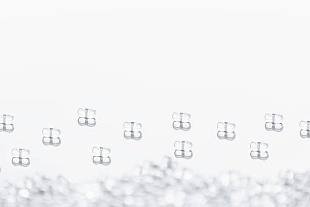 istock Minimalist abstract light background with transparent glass particles. 521468514