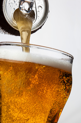 Pouring ice cool beer from a ring pull can