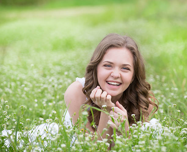 istock Young beautiful woman lying on the grass 521471108
