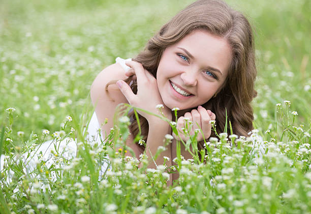 istock Young beautiful woman lying on the grass 521471136
