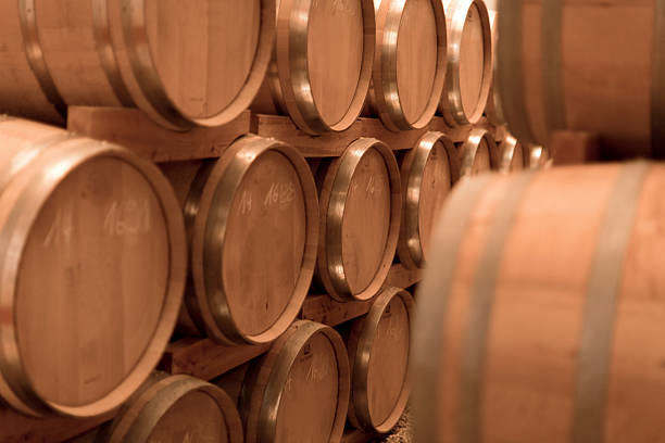 istock Old oak tree whiskey barrels in a storage warehouse 521471346