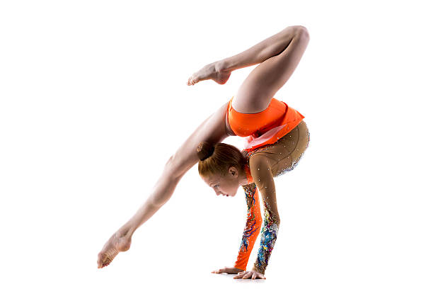Teenage dancer girl doing handstand Beautiful gymnast athlete teenage girl wearing dancer colorful leotard working out, dancing, doing backbend, handstand exercise, back walkover, full length, studio, white background, isolated acrobatic activity stock pictures, royalty-free photos & images
