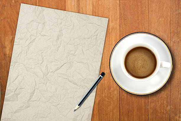 istock paper and a white coffee cup on a wooden desk 521472115