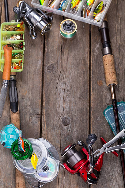 istock fishing tackles and baits on wooden board 521472802