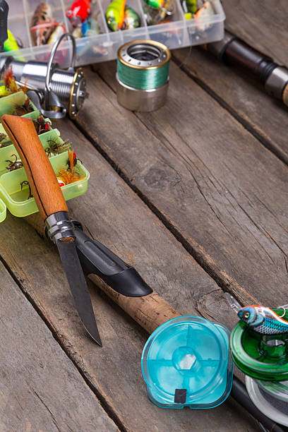 istock fishing tackles and baits on wooden board 521473080