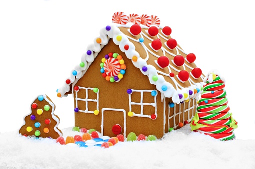 Colorful gingerbread house in snow with lollipop tree isolated on white