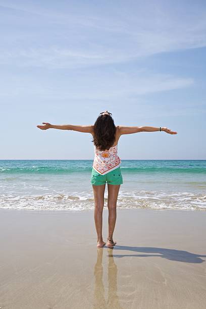 istock happy woman greeting sky 521488609