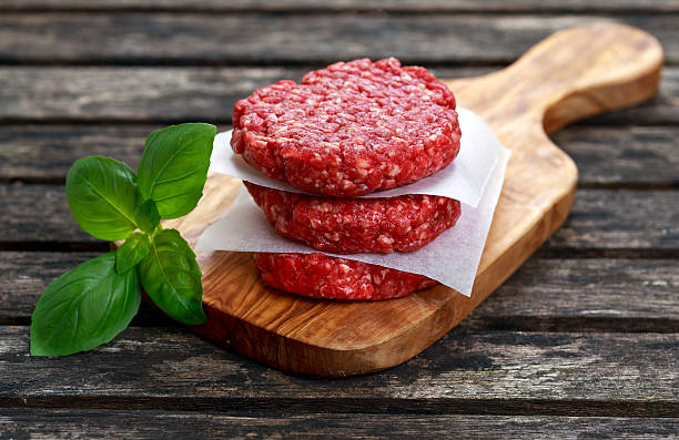 istock Home HandMade Minced Beef burgers on cutting board. 521491622