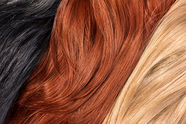 istock Long blond, black, red human shiny hair 521492069