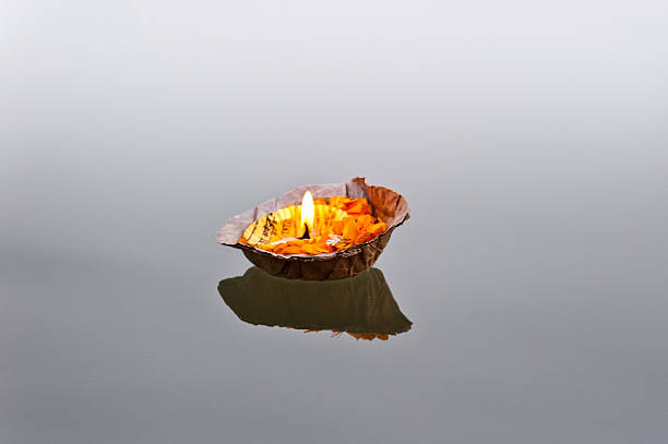 istock Burning pooja candle on the Ganges 521492106