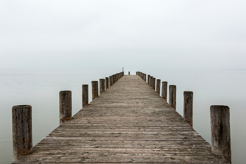 Deserted jetty, pier in foggy weather, horizontal shot