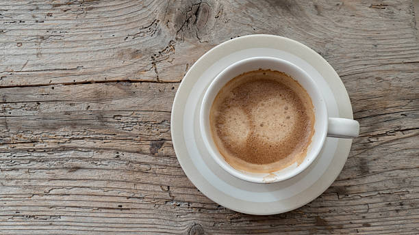 istock Top view of coffee cup over wooden background 521492652