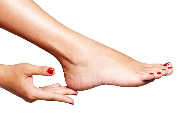 Closeup photo of a female feet with beautiful red pedicure stock photo