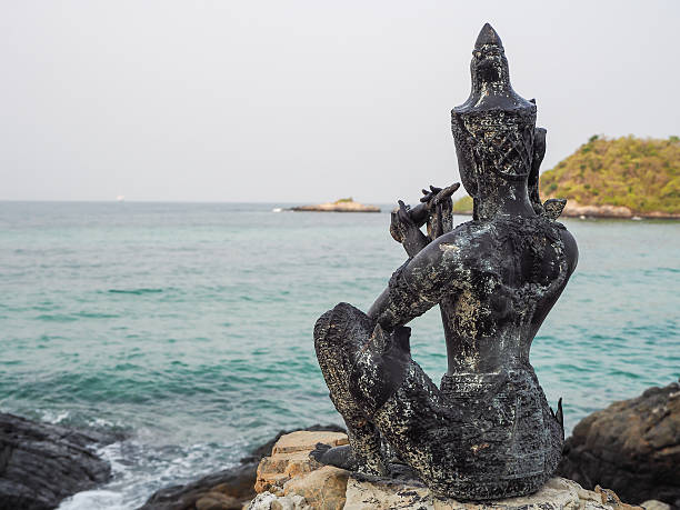 istock Statue of the king on rocks. 521493984