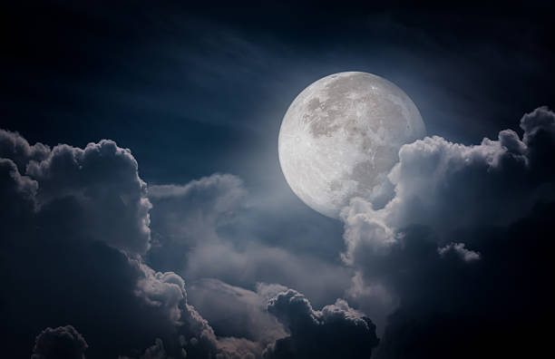 Nighttime sky with clouds, full moon would make great background Attractive photo of a nighttime sky with clouds, bright full moon would make a great background. Nightly sky with large moon. Beautiful nature use as background. Outdoors. planetary moon photos stock pictures, royalty-free photos & images