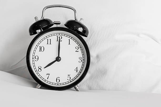 istock Still life with vintage alarm clock on bed 521495498