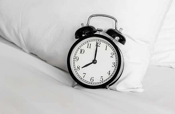 istock Still life with vintage alarm clock on bed 521495544