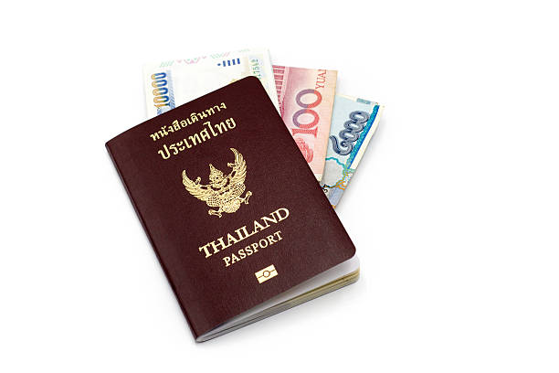 istock Thailand passport book and bank note on white 521495908