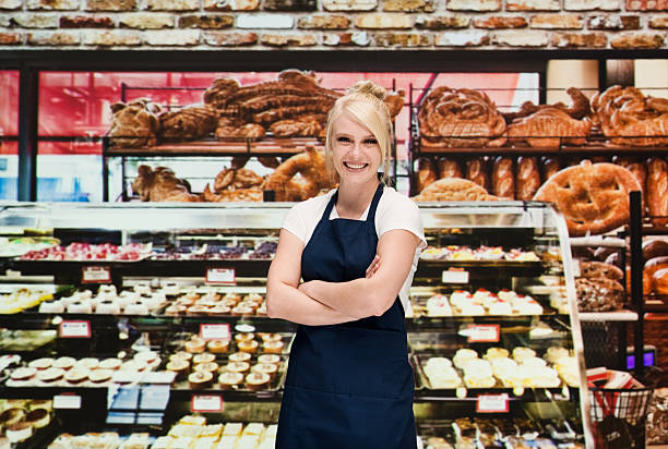 istock Cheerful baker standing with arms crossed 521495910
