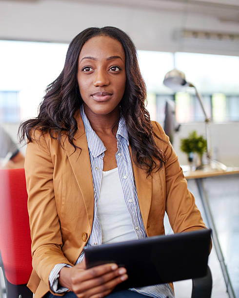 istock Confident female designer working on a digital tablet in red 521496786