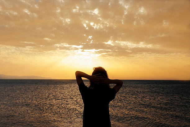 istock The woman silhouette with sunset 521498070