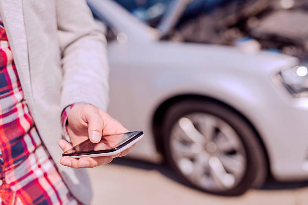 istock Man using smart phone and call the car insurance 521498108