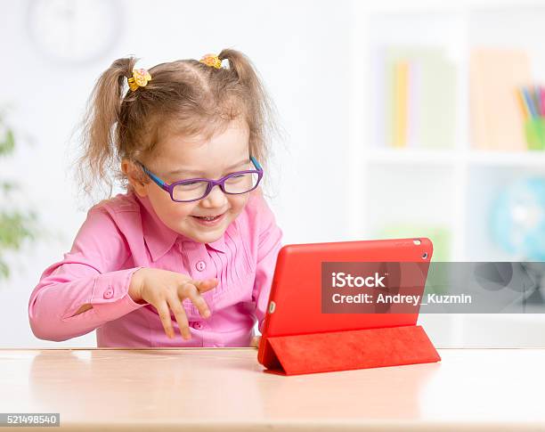 Kid With Tablet Pc In Glasses Learning Stock Photo - Download Image Now - Digital Tablet, Preschool, Child