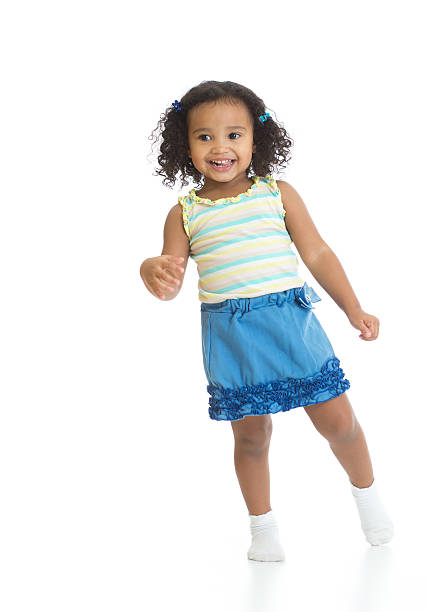 istock Kid girl standing or dancing full length isolated 521499612