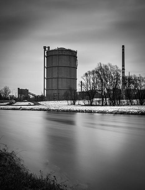 Gasometer near river photography
