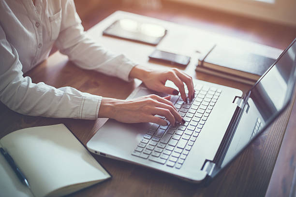 istock Female working with laptop at home woman's hands on 521503122