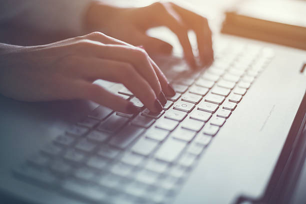 istock Woman working in home office hand on keyboard close up 521503214