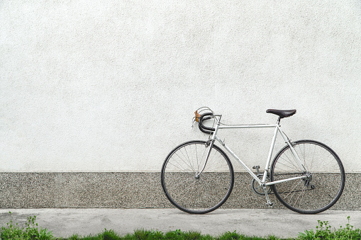 Vintage sport bicycle next to white wall.