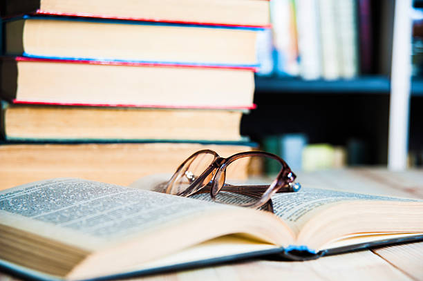 istock book and glasses on table in library 521506386