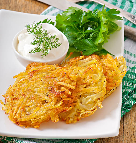 istock Fragrant potato pancakes with sour cream and herbs 521511829