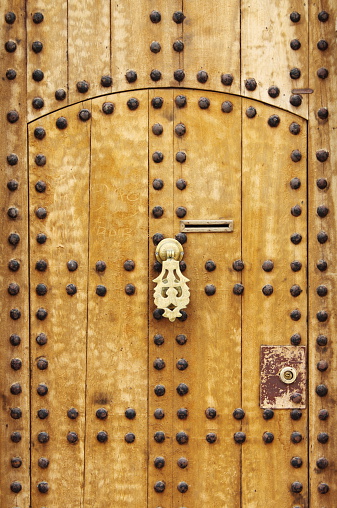 Wooden door with arab style doorknob in Marrakech, Morocco