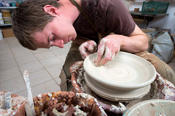 istock hands of a potter, creating an earthen jar 521514353