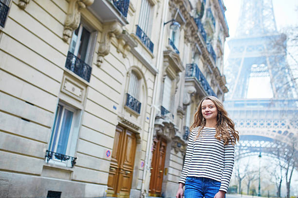 istock Girl outdoors near the Eiffel tower, in Paris 521526892