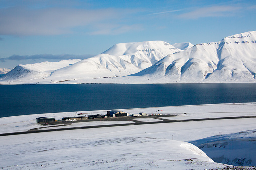 Spitzbergen Longyearbyen Airport with isfjord and winter landscape, bright weather, image with plenty of copy space.