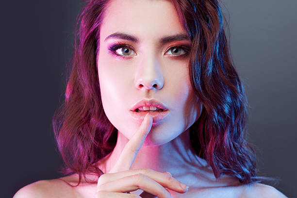 istock Attractive young brunette presses a finger to his lips. The 521529468