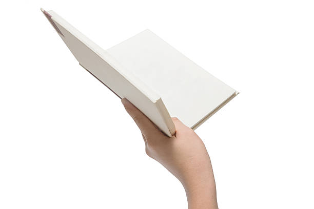 istock Hand holding white book isolated on white 521529550