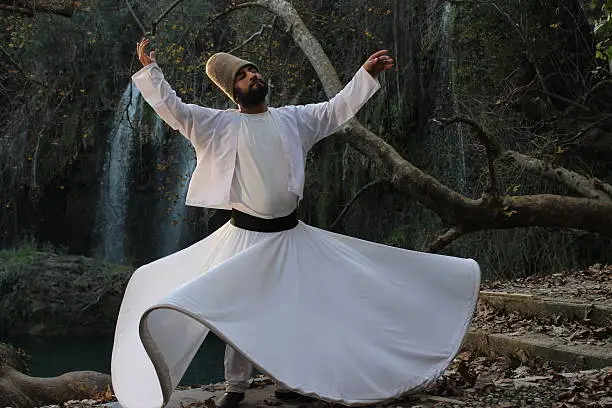 Antalya, Turkey - December 28, 2015: Whirling dervish (Ishak Urun) at the Kursunlu Waterfall. Photograph taken during the TV show (TRT)