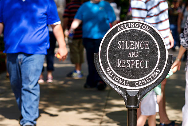 Close-up, Sign "Silence and Respect", Tomb of the Unknown Soldier Arlington, Virginia, USA - May 24, 2015: A sign reminds tourists to be silent and respectful at the Tomb of the Unknown Soldier at Arlington National Cemetery. arlington cemetery in spring stock pictures, royalty-free photos & images
