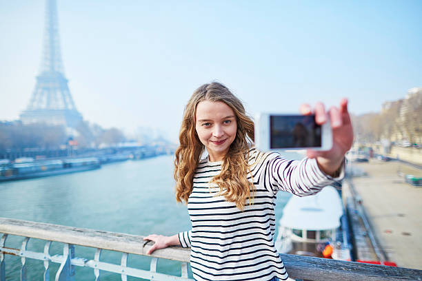 istock Young girl taking selfie near the Eiffel tower 521531232