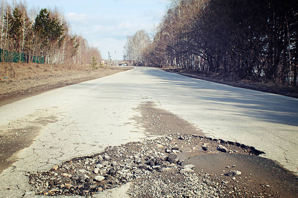 istock Large pit on the suburban road 521532680